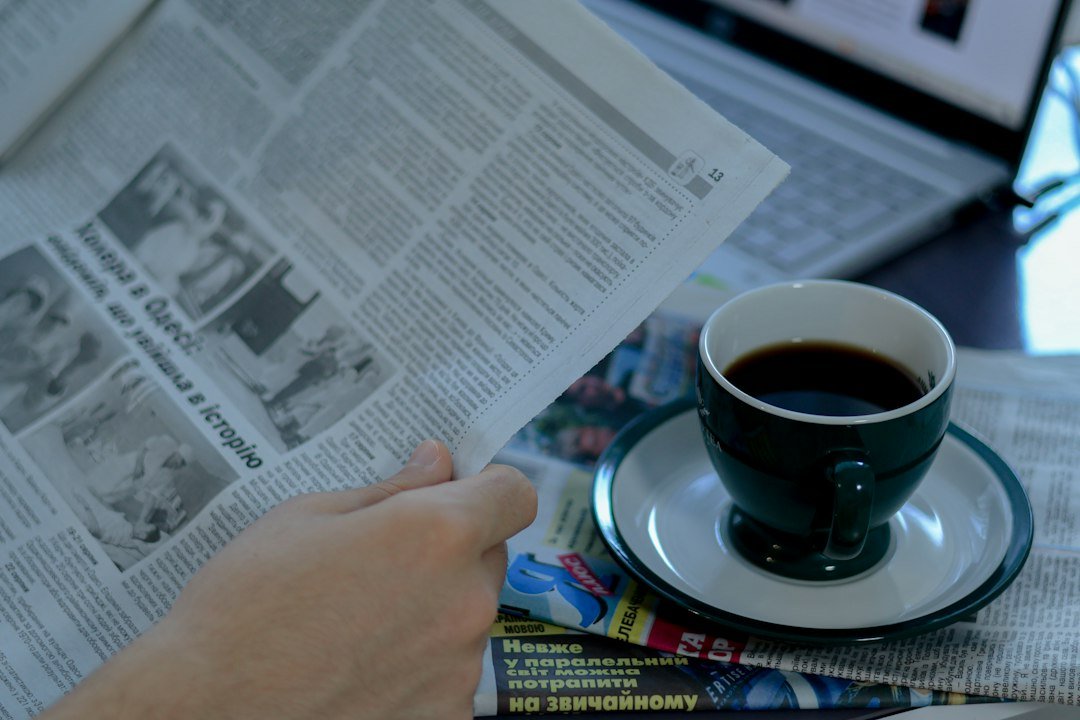 Reader reviewing the news over a morning coffee