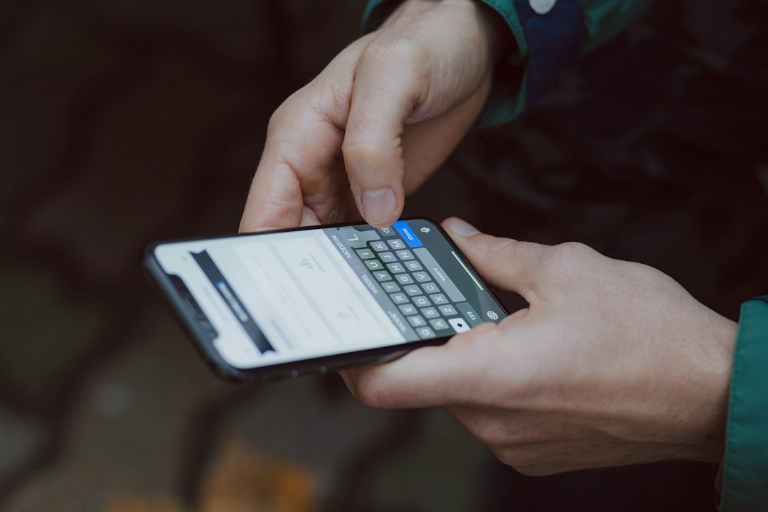 Person using a smartphone, illustrating online safety and scam awareness