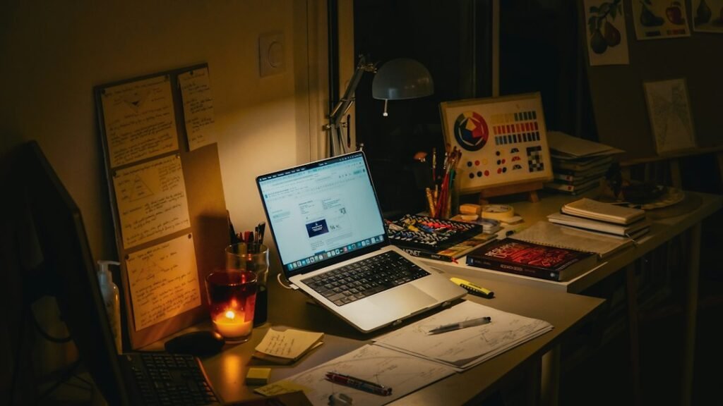 Research workspace with a laptop, books and notebook